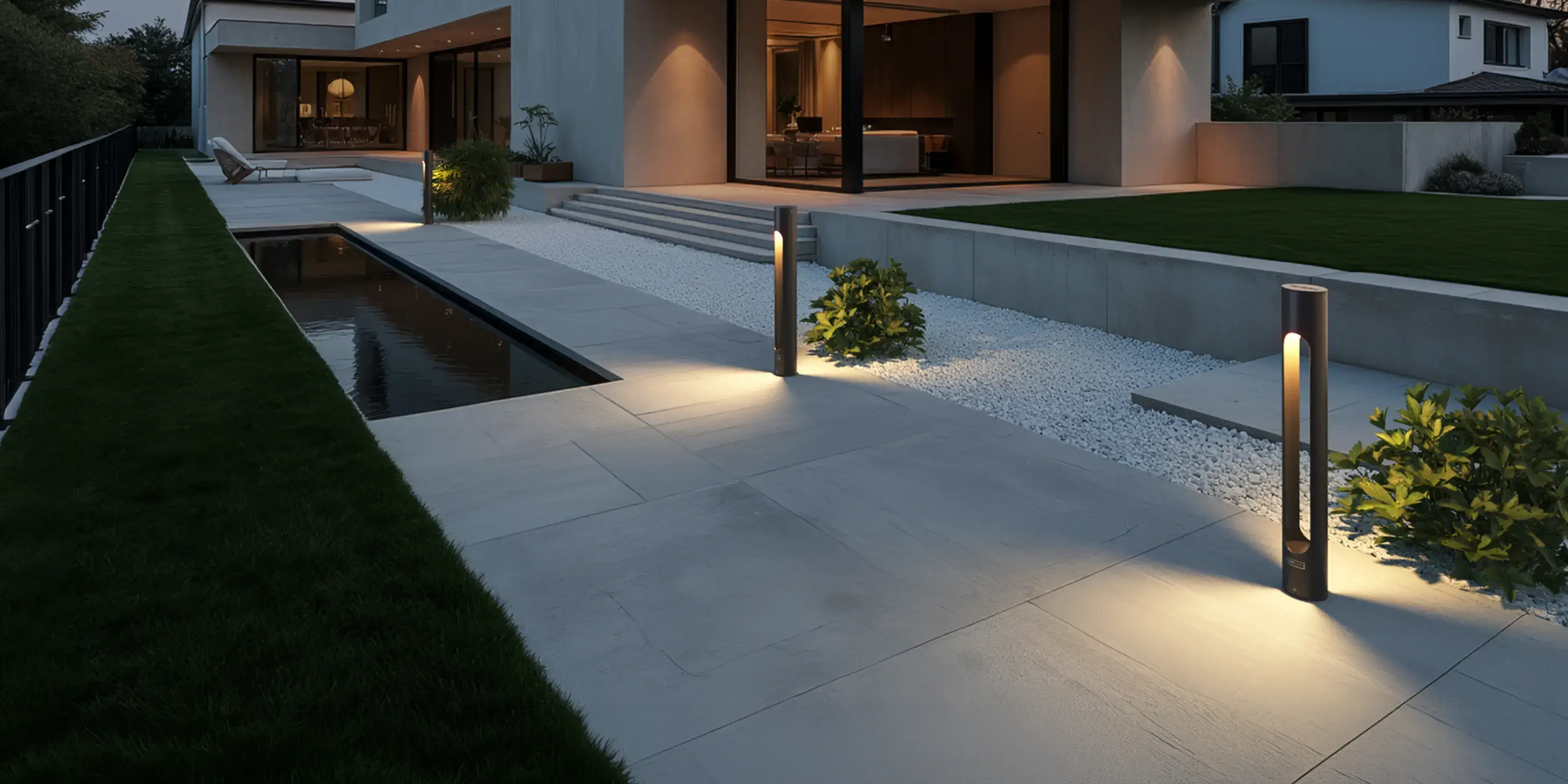 Fonelight Velora bollard lights lining a paved garden path at dusk